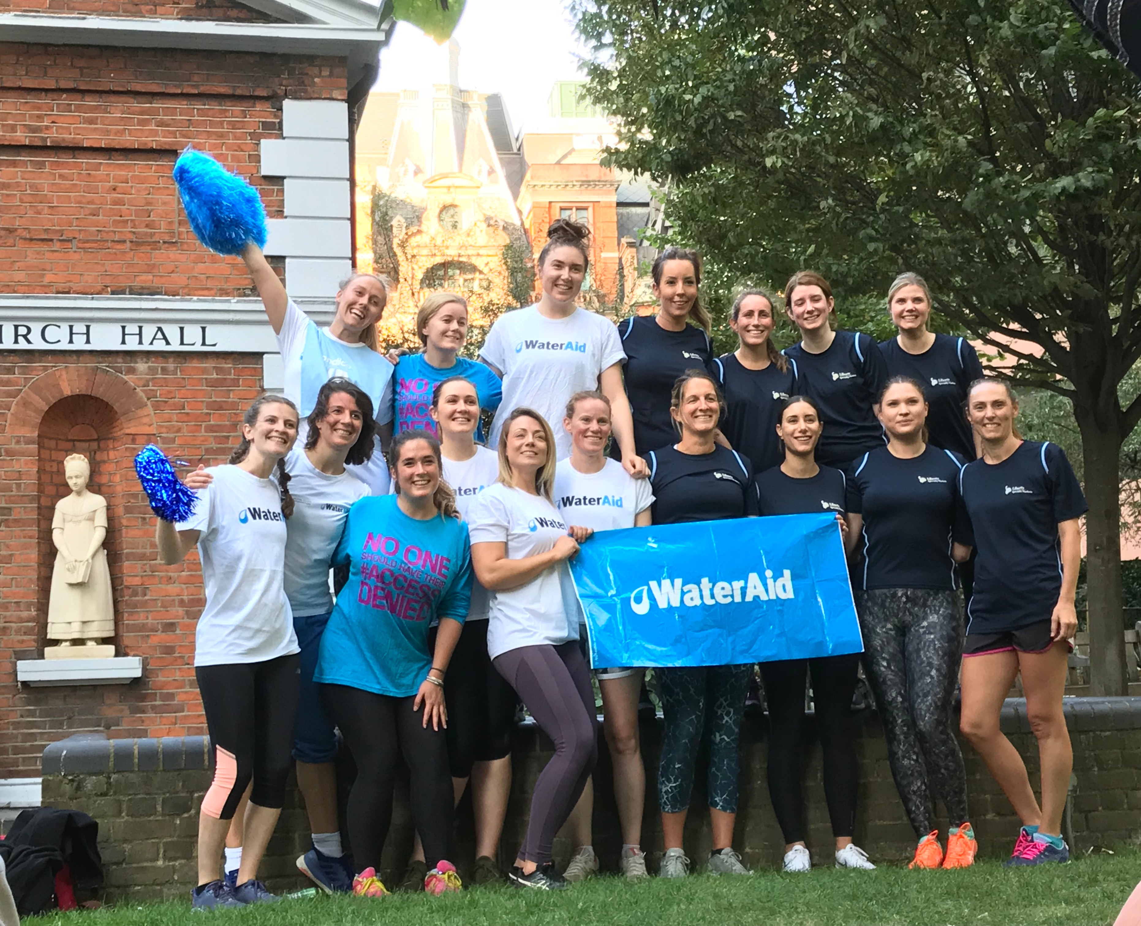 People smiling holding wateraid banner